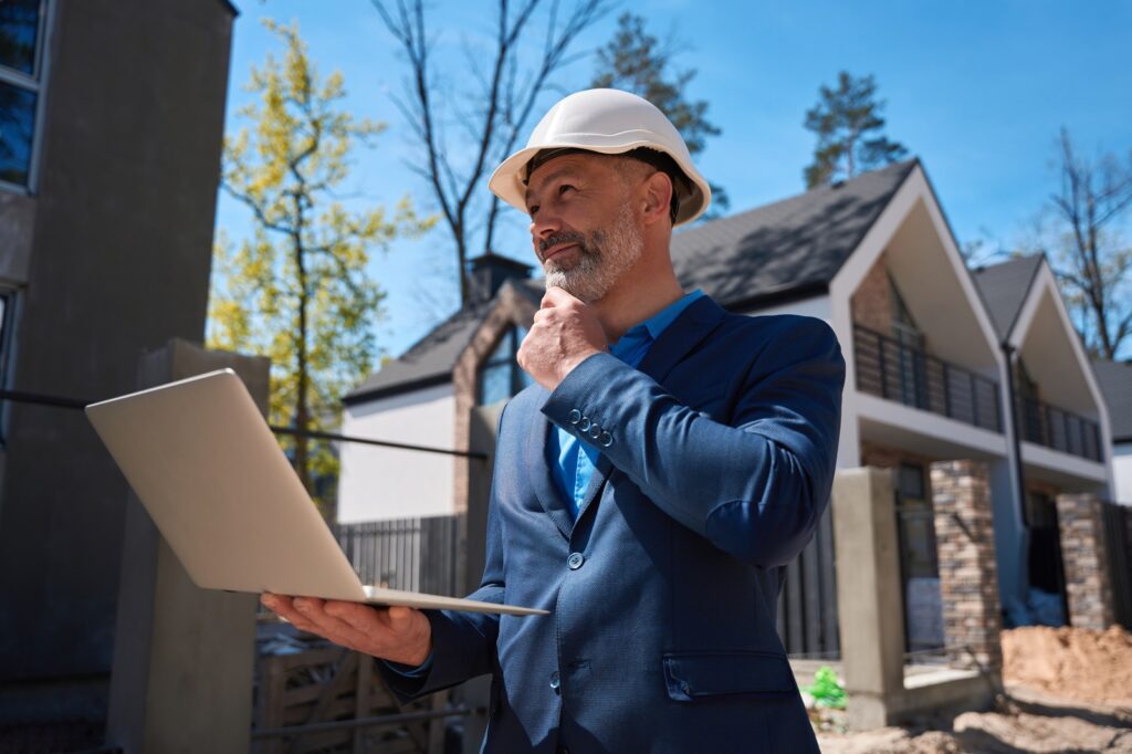 Smiling Businessman Inspecting Sewer Line Via 3d Building Model Resized